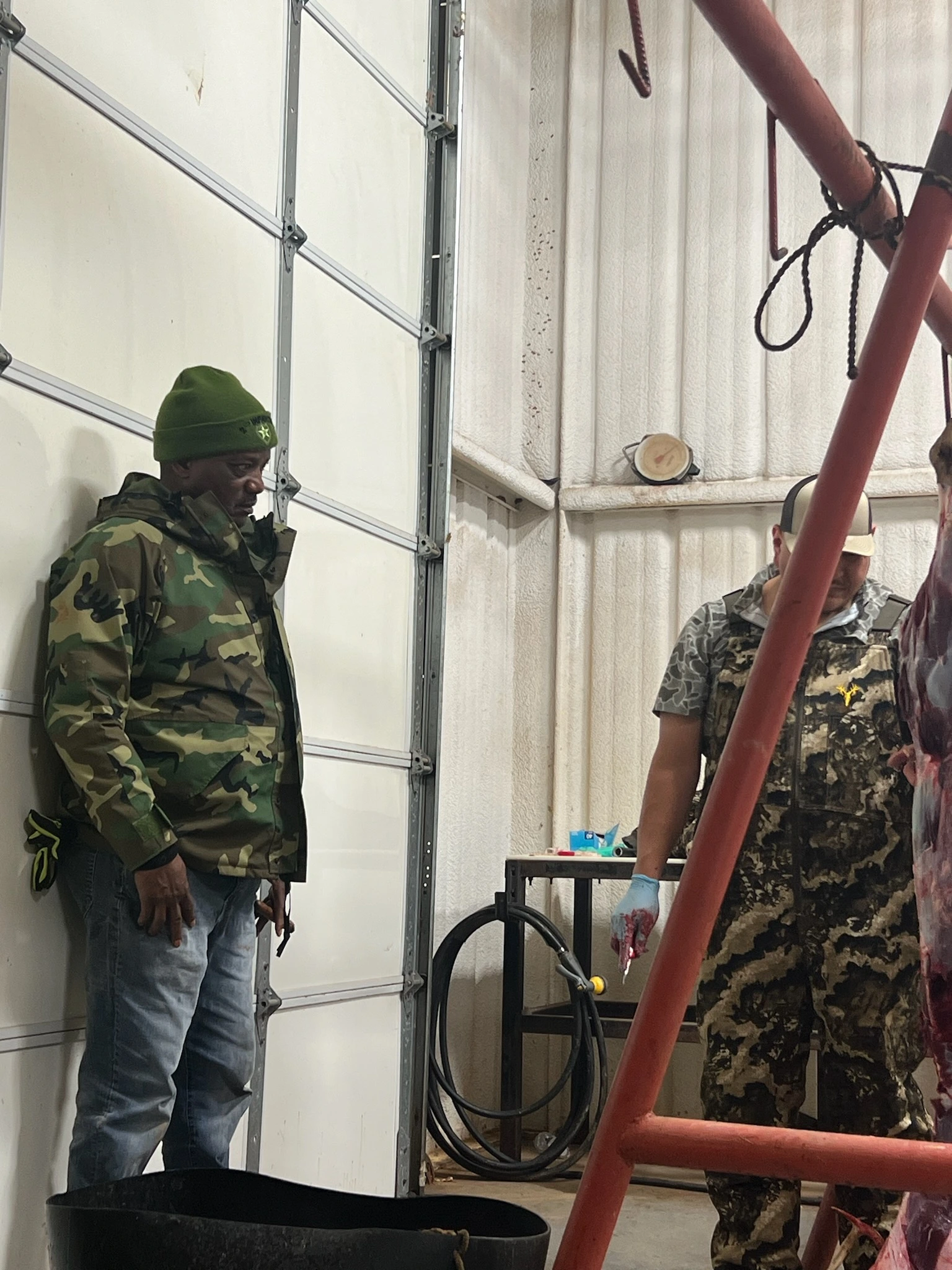 Veterans hanging out while quartering a deer at the Hapgood Ranch during a hunting trip