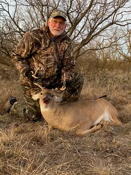 Veteran posing for a photo with a buck deer harvested during a hunting trip with the Texas Hunting & Fishing Guides for Veterans nonprofit