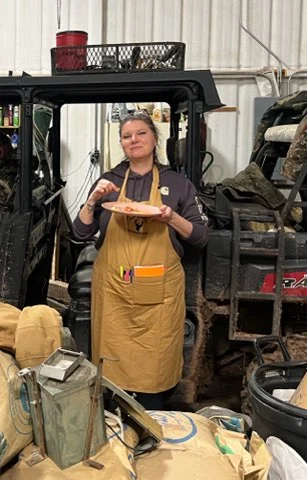 One of our volunteer cooks enjoying a meal with veterans at the end of a hunting trip